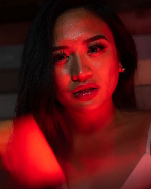 A dramatic scene under moody red lighting