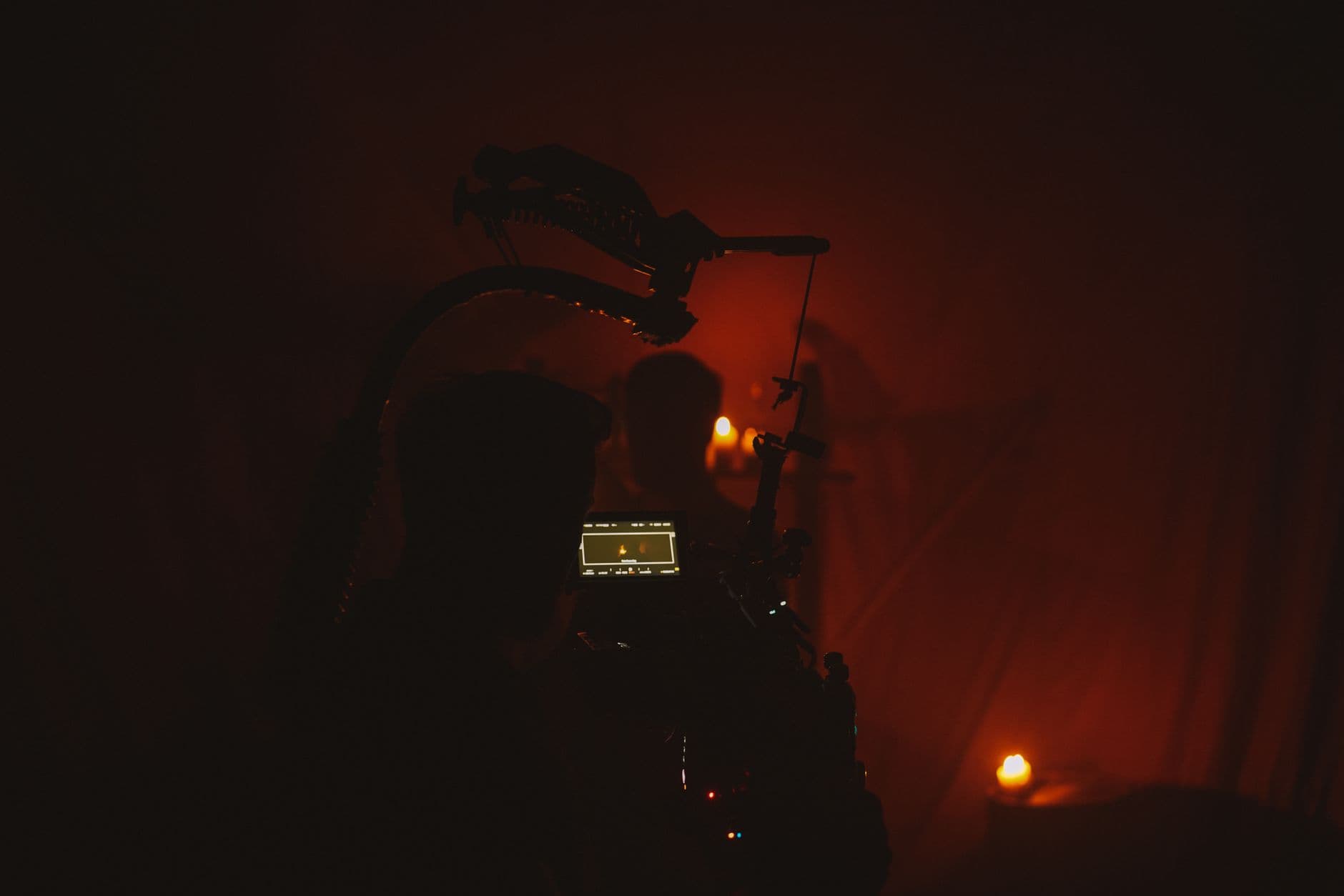 A camera monitor glowing in a dark studio during a night shoot